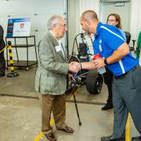 Seymour Padnos shaking hand of an engineering student.